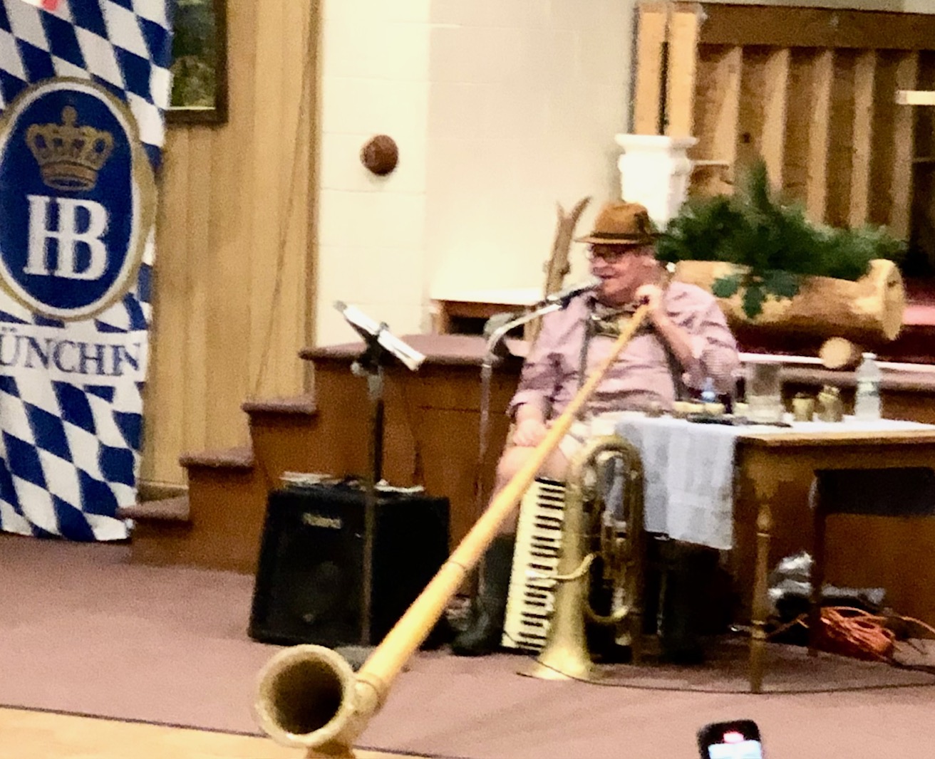 An alphorn player performing at Maifest