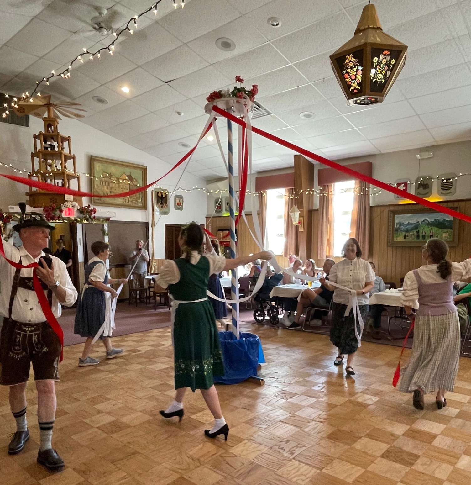 Dancers circling the Maibaum with ribbons at Maifest